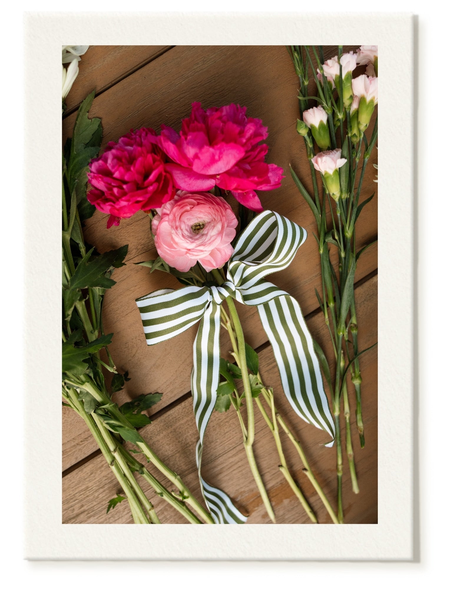 Soft pink peonies and ranunculus with striped ribbon for bridal shower florals
